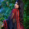 Alternate view of a red and black saree photographed outdoors