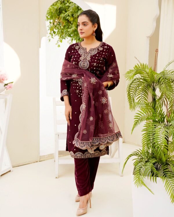Model wearing an embroidered three-piece set indoors